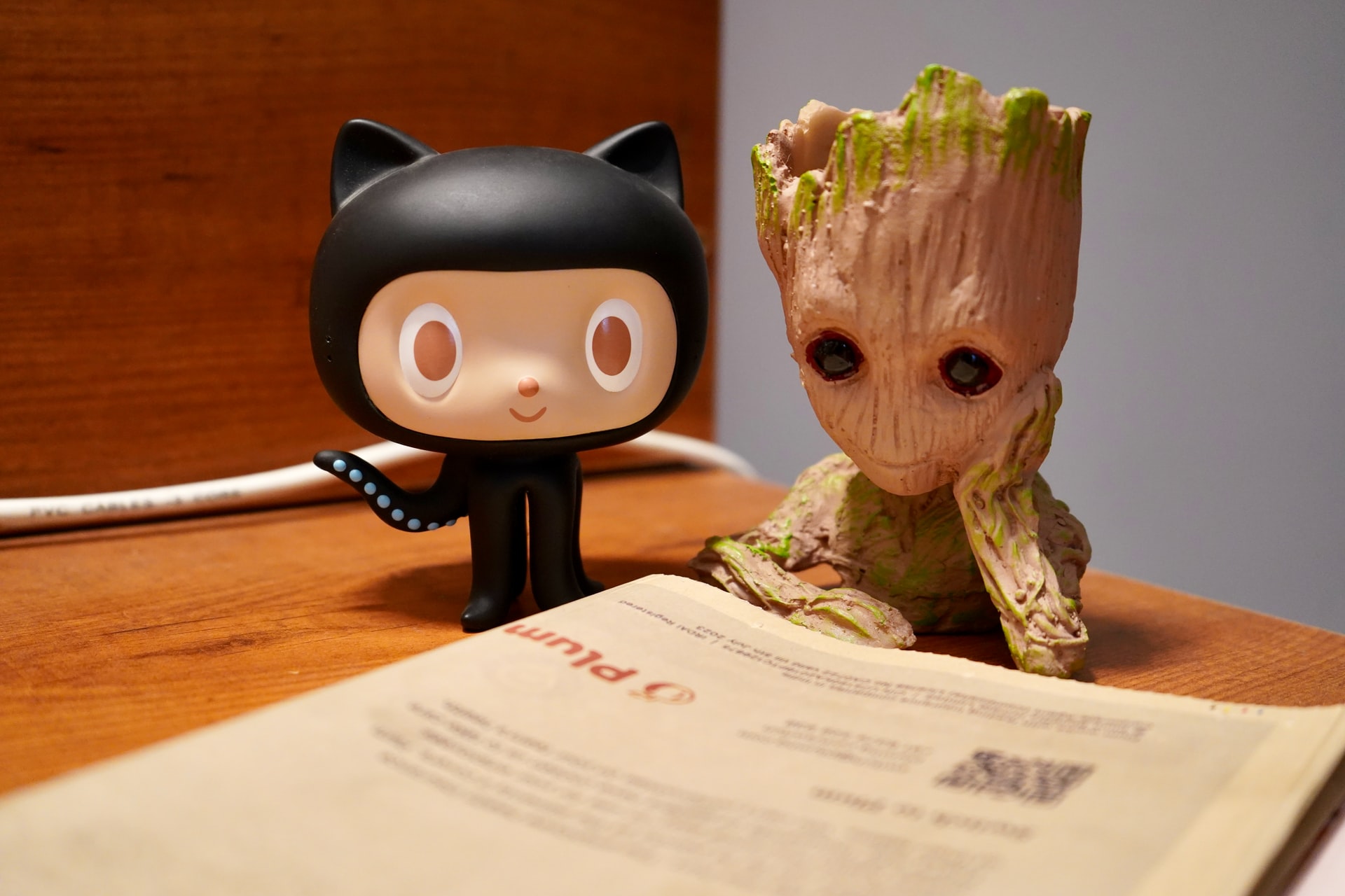 Groot and Octocat reading a newspaper